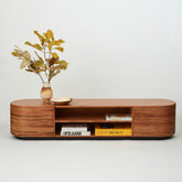 Panama rattan entertainment unit styled in a modern living room, concealing tech clutter and displaying books and décor.